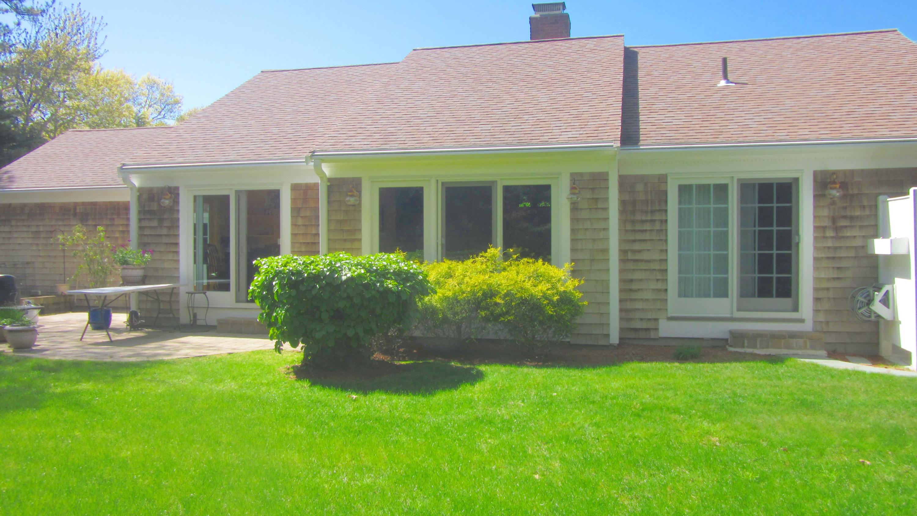 114 Sullivan Road West Yarmouth, MA 02673 - Photo 4 of 41 a front view of a house with garden and porch