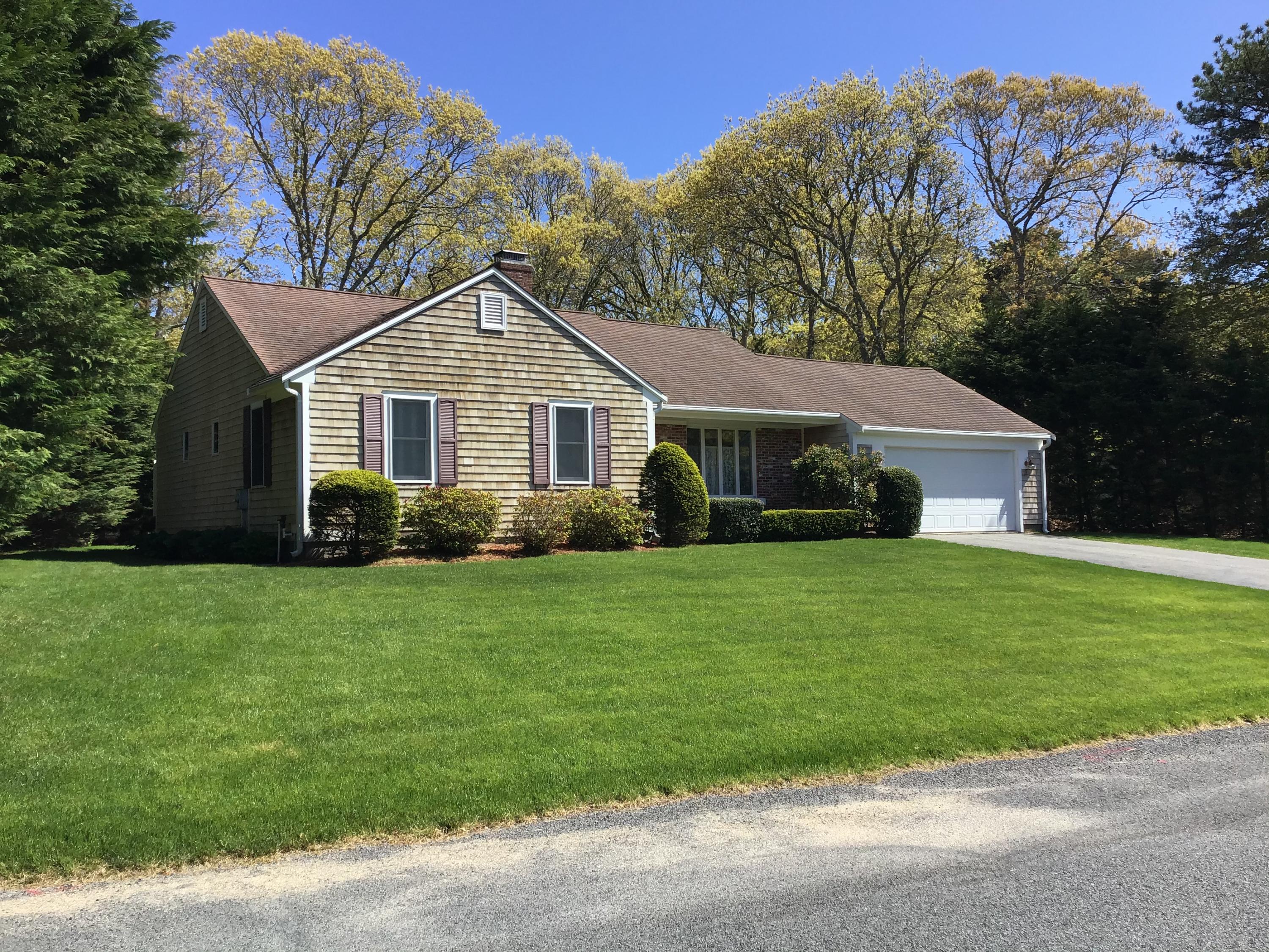 114 Sullivan Road West Yarmouth, MA 02673 - Photo 7 of 41 a front view of a house with a garden