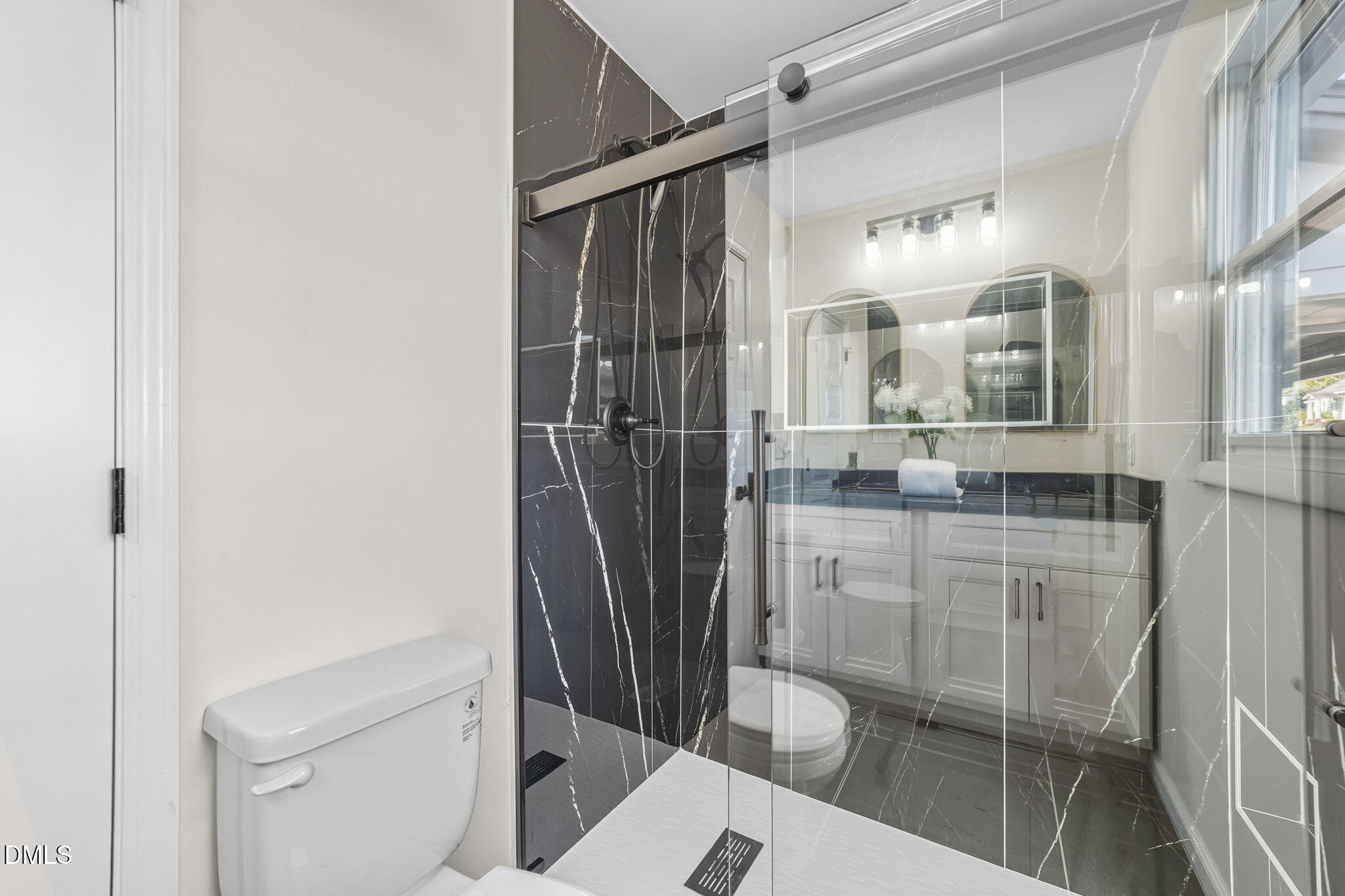 303 West 2nd Street Clayton, NC 27520 - Photo 11 of 44 a bathroom with a shower and toilet