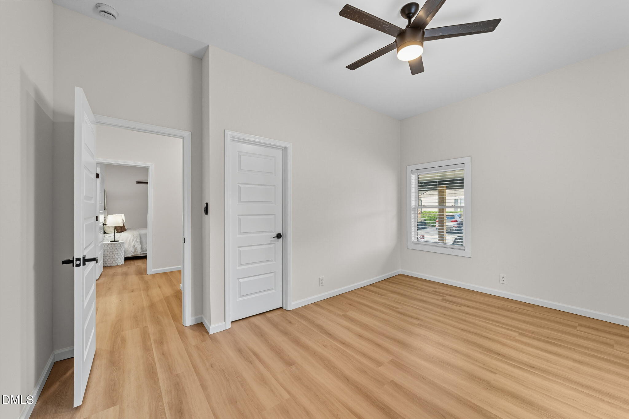 303 West 2nd Street Clayton, NC 27520 - Photo 12 of 44 a view of a room with wooden floor and a ceiling fan