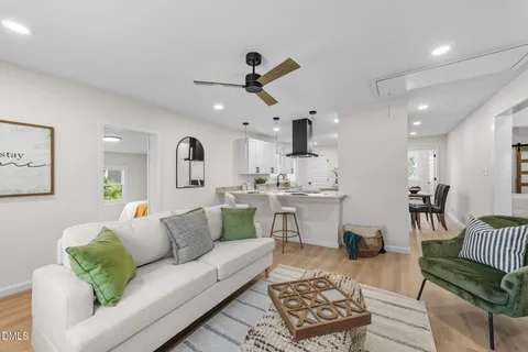 a kitchen with stainless steel appliances granite countertop a sink refrigerator and cabinets