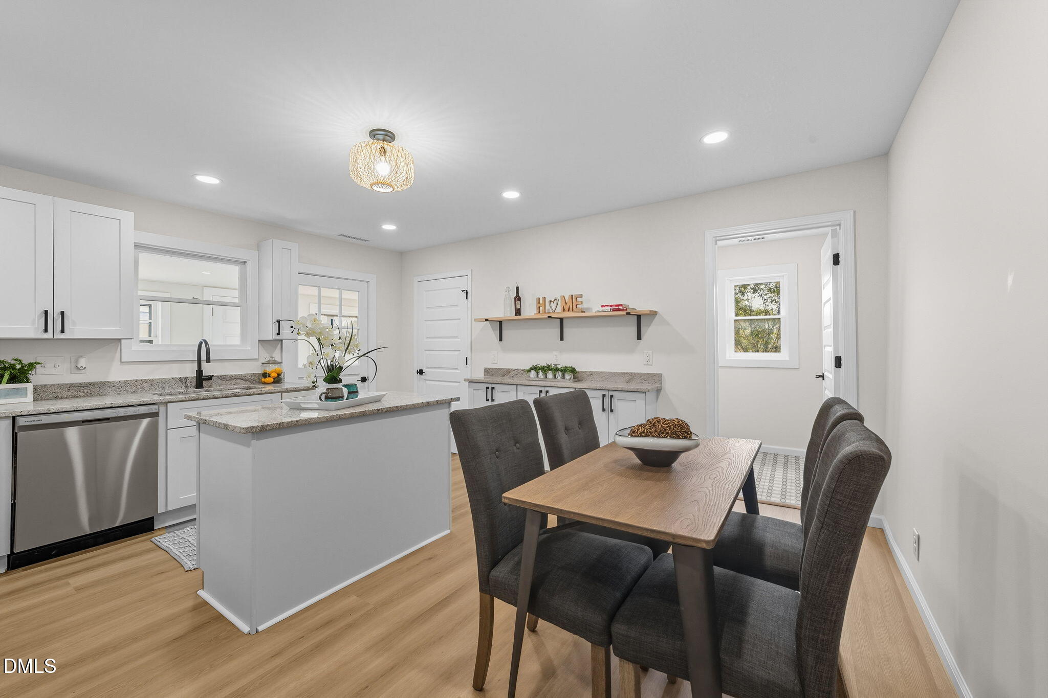 303 West 2nd Street Clayton, NC 27520 - Photo 20 of 44 a kitchen with a dining table chairs and wooden floor