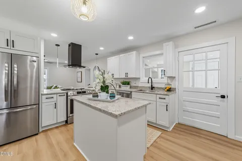 a kitchen with a sink stove and cabinets