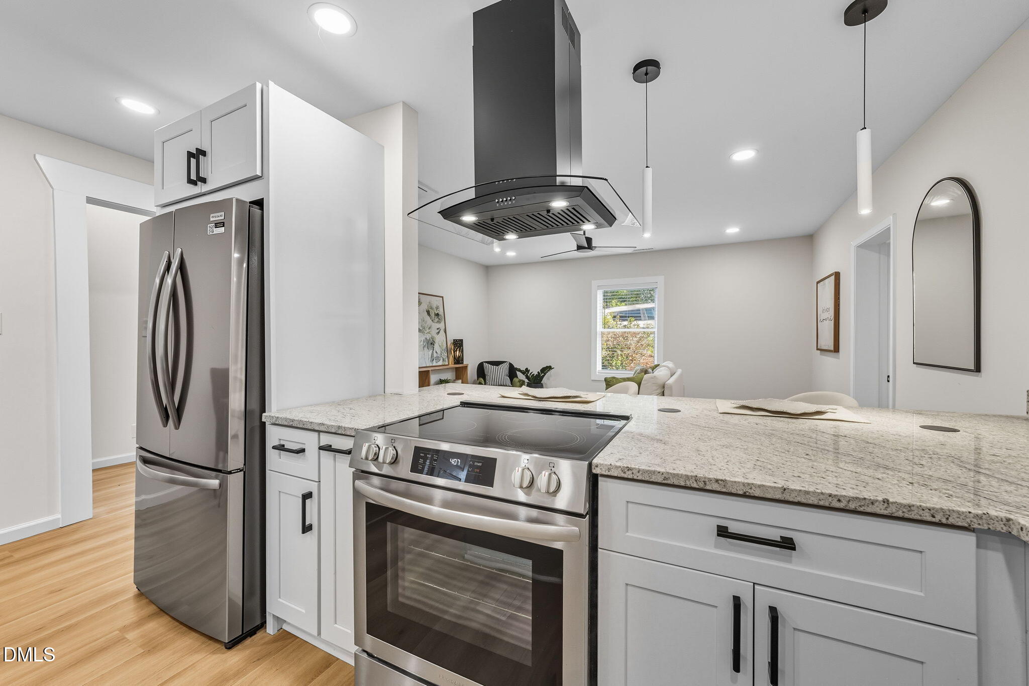 303 West 2nd Street Clayton, NC 27520 - Photo 23 of 44 a kitchen with stainless steel appliances granite countertop a refrigerator a stove and a sink with wooden floor