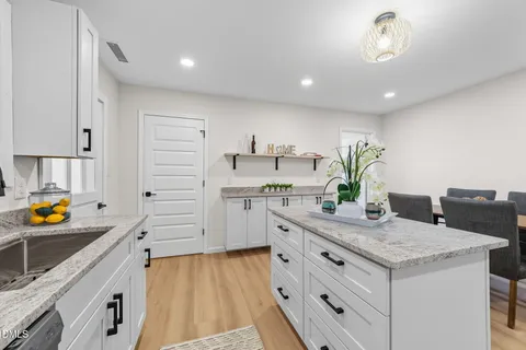 a kitchen with stainless steel appliances granite countertop a sink and a stove