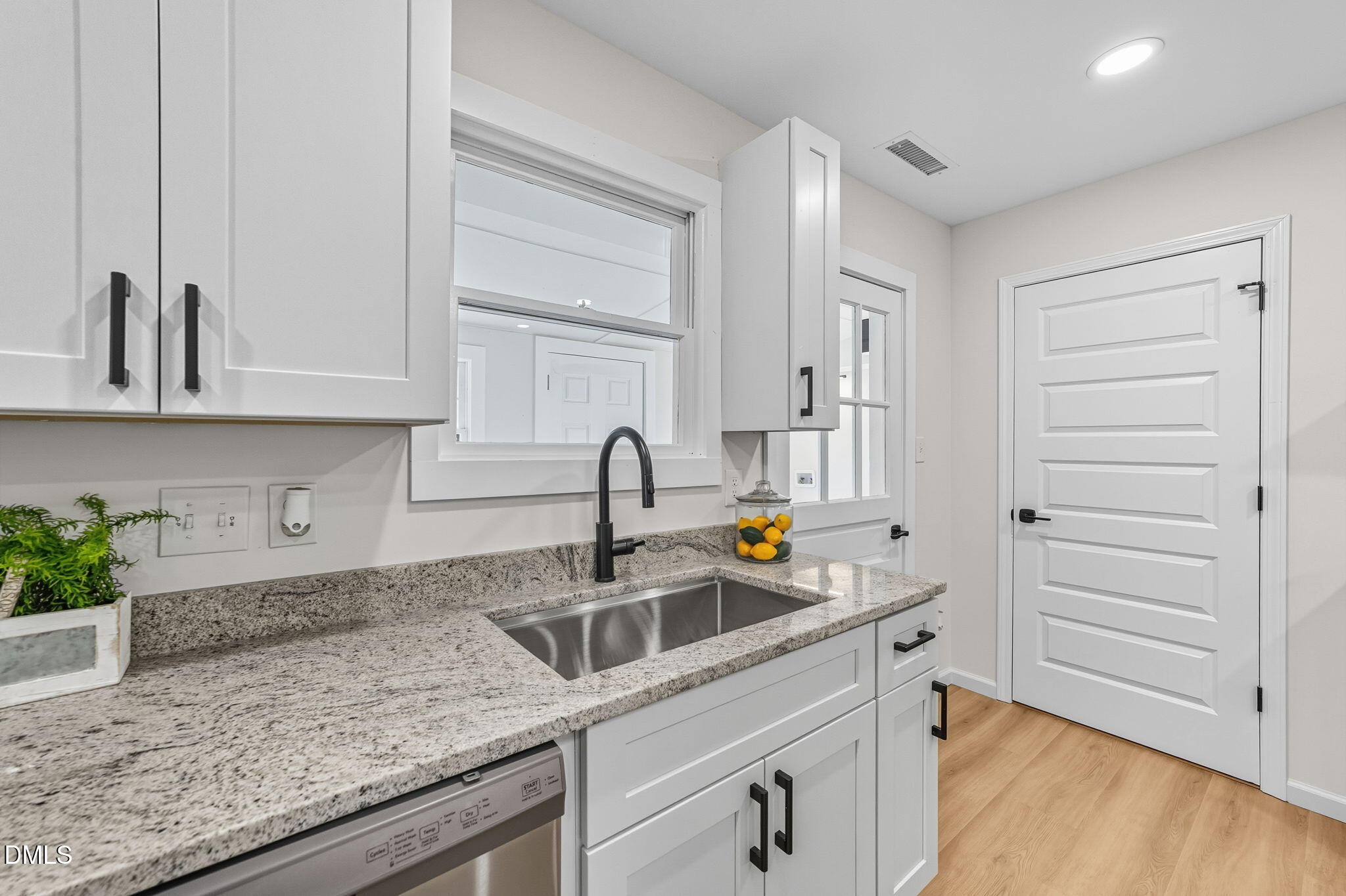 303 West 2nd Street Clayton, NC 27520 - Photo 25 of 44 a kitchen with stainless steel appliances granite countertop a sink and a stove