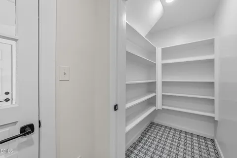a view of a bathroom with a walk in closet