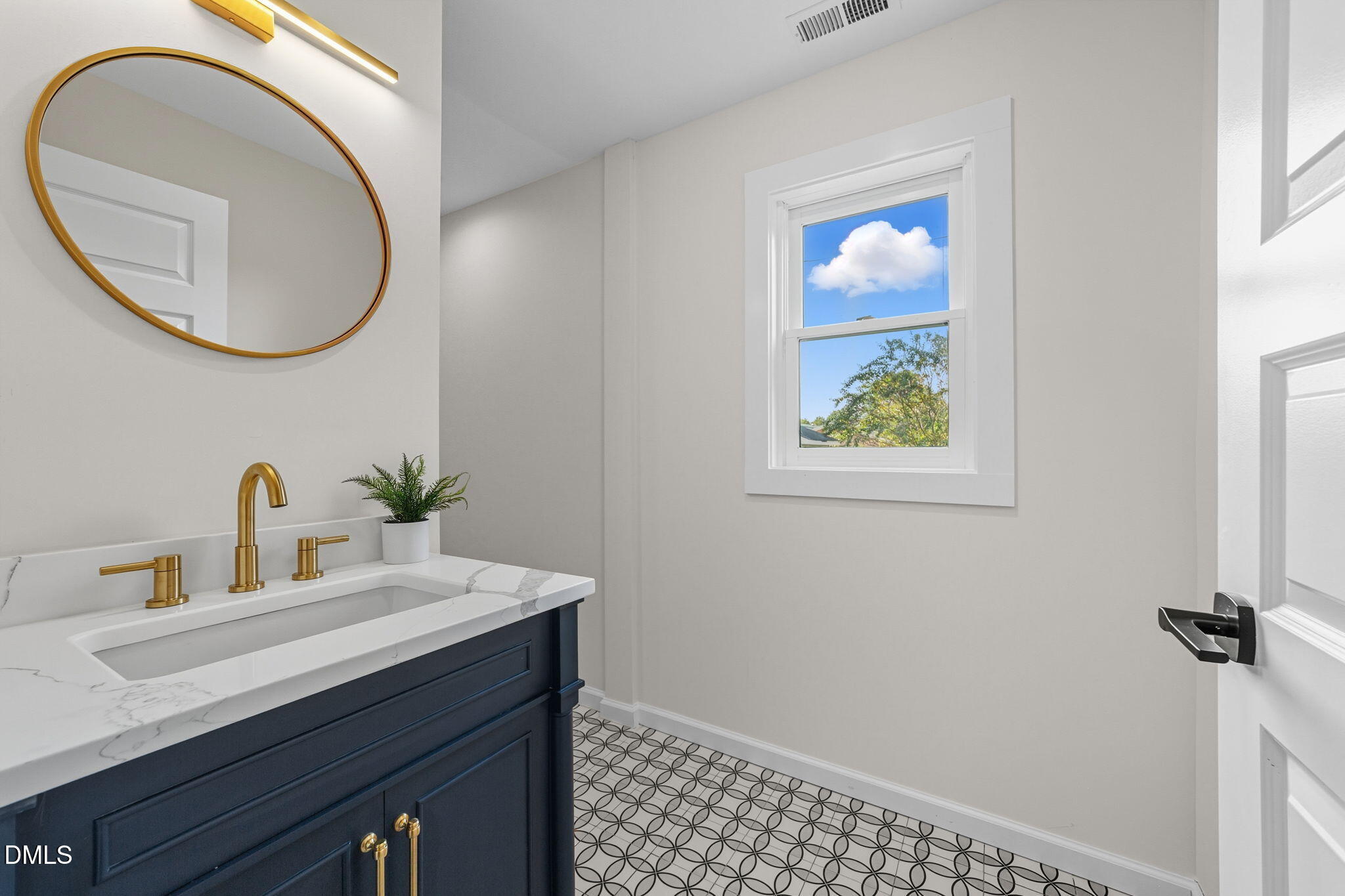 303 West 2nd Street Clayton, NC 27520 - Photo 29 of 44 a bathroom with a sink a vanity and a mirror