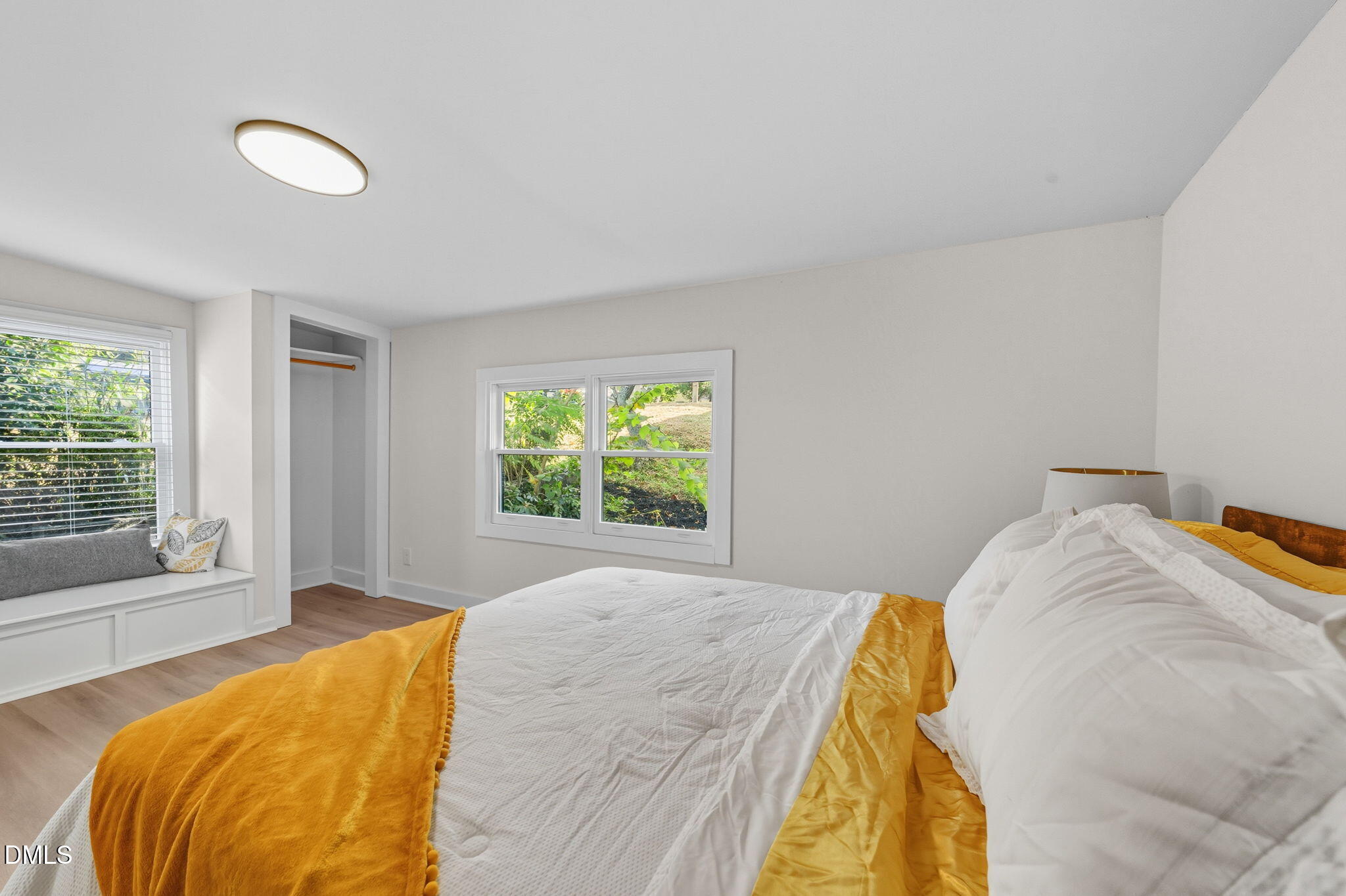 303 West 2nd Street Clayton, NC 27520 - Photo 32 of 44 a bed sitting in a bedroom next to a window