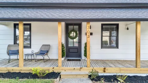 a view of a backyard with plants and a patio