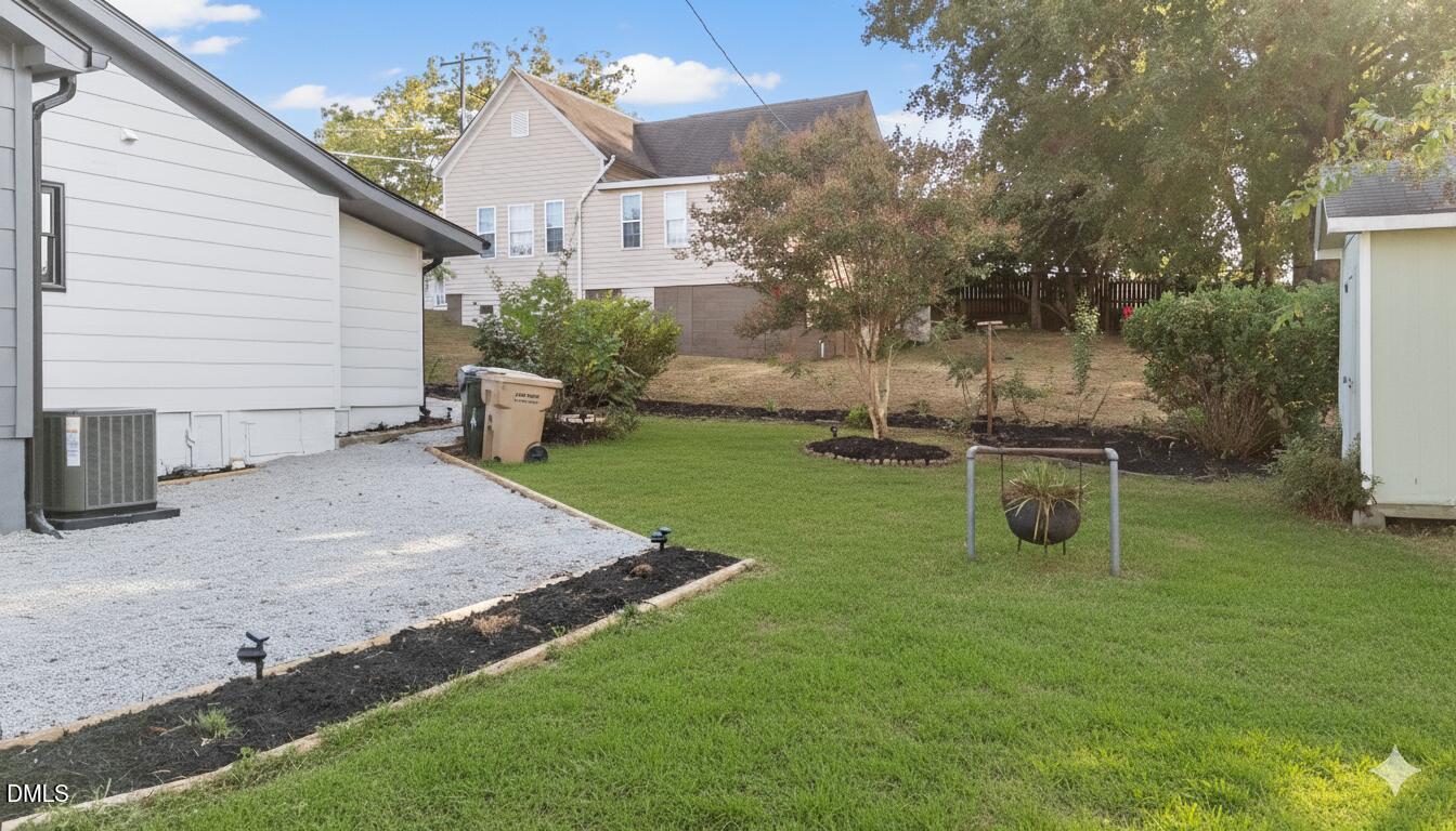 303 West 2nd Street Clayton, NC 27520 - Photo 37 of 44 a view of a backyard with plants and a patio