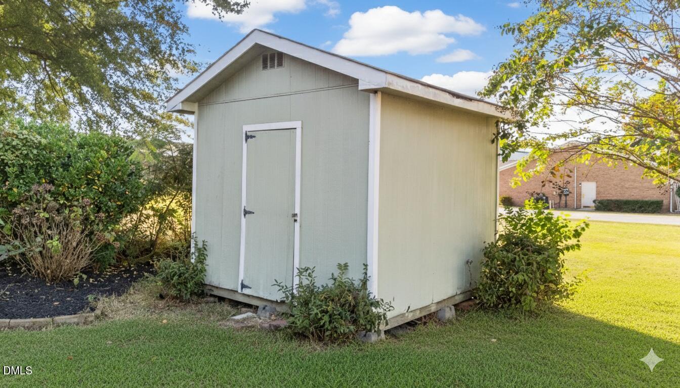 303 West 2nd Street Clayton, NC 27520 - Photo 38 of 44 a house view with a garden space