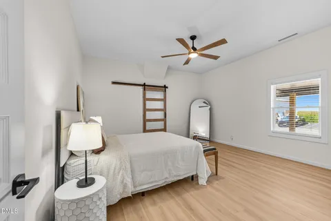 a bedroom with a bed and a ceiling fan