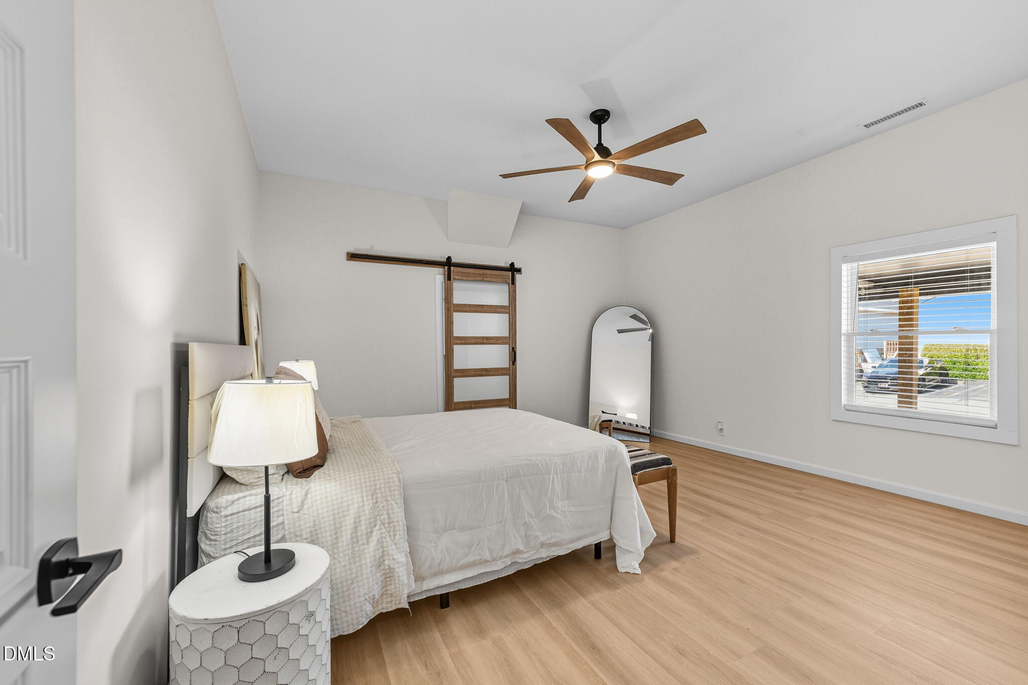 303 West 2nd Street Clayton, NC 27520 - Photo 6 of 44 a bedroom with a bed and dresser with wooden floor