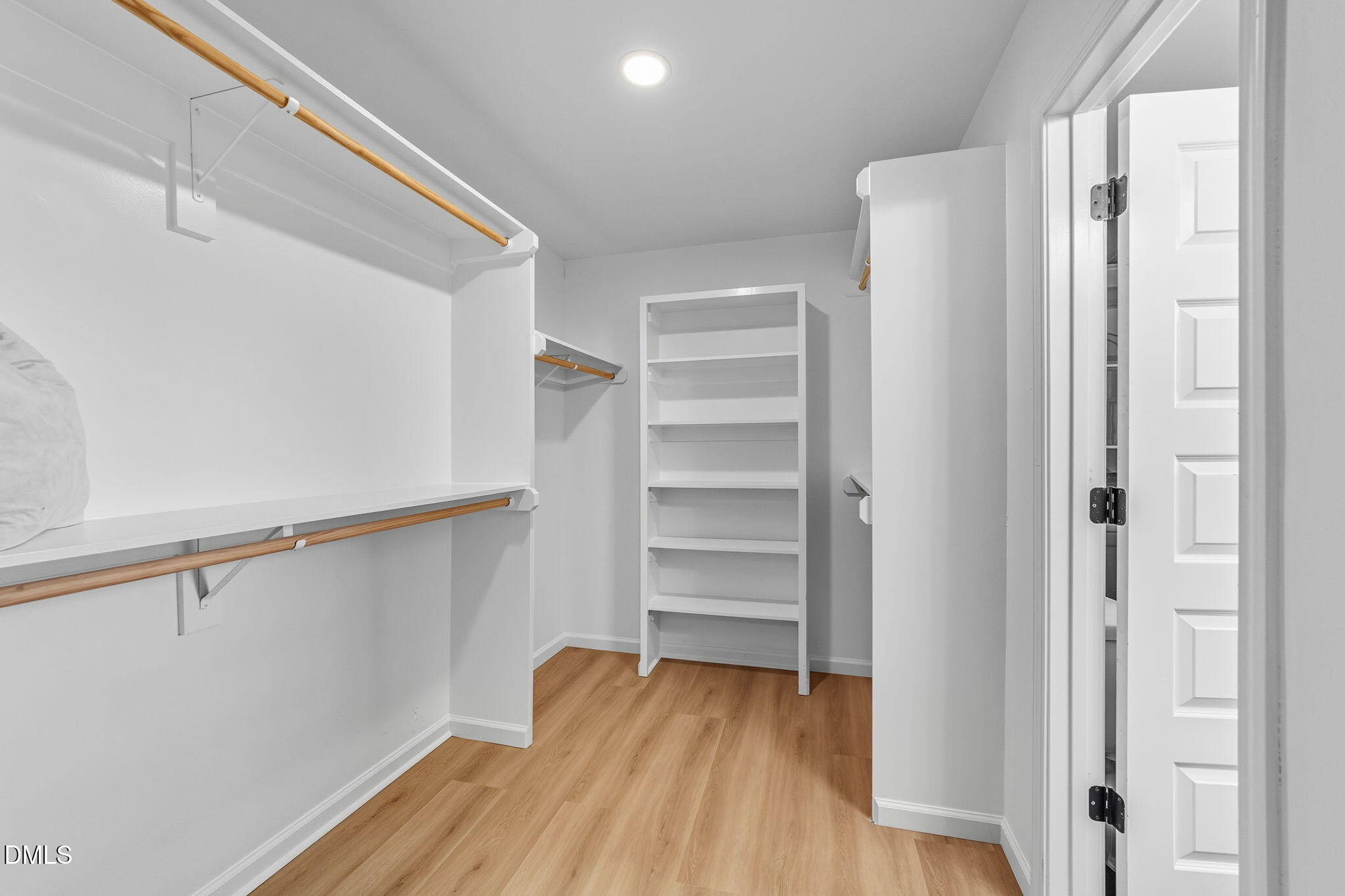 303 West 2nd Street Clayton, NC 27520 - Photo 9 of 44 a view of walk in closet with empty racks