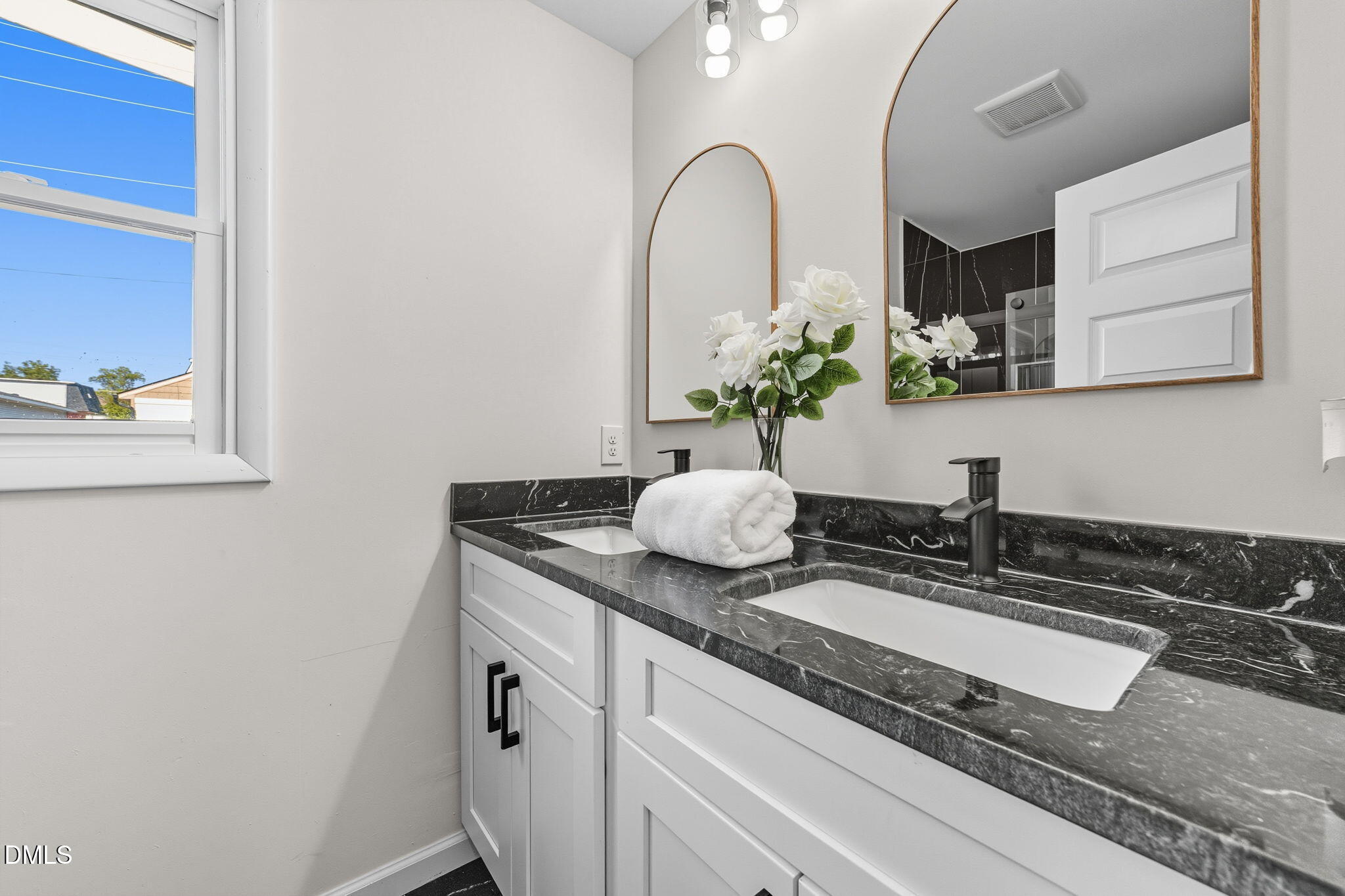 303 West 2nd Street Clayton, NC 27520 - Photo 10 of 44 a granite counter top a sink and a mirror