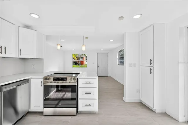 a bathroom with a granite countertop bathtub shower sink vanity and toilet