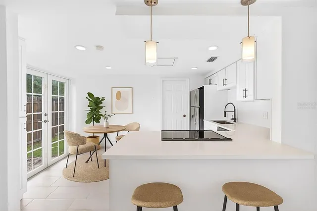 a living room with furniture a table and a potted plant