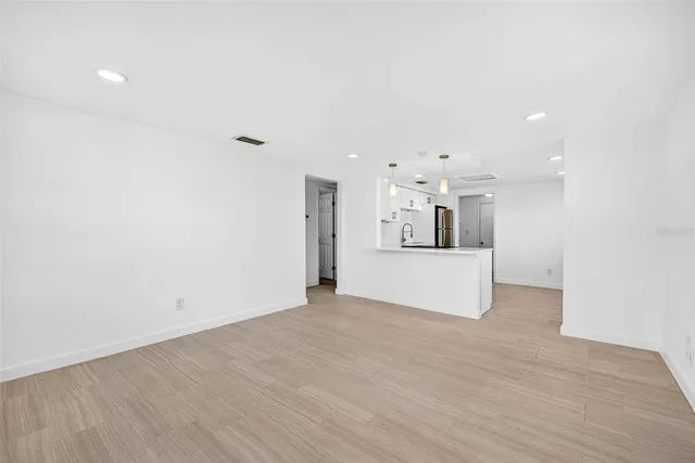 a kitchen with a refrigerator a stove top oven a sink and cabinets