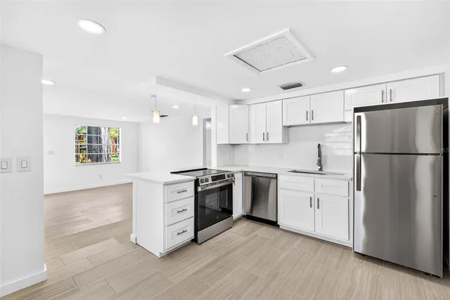 an empty room with a window and wooden floor
