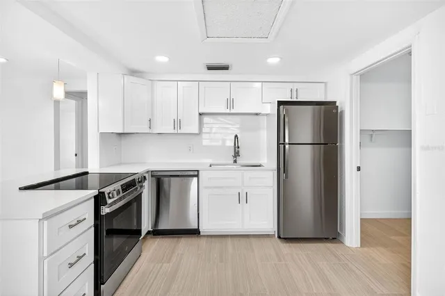 a view of a hallway with wooden floor and entryway