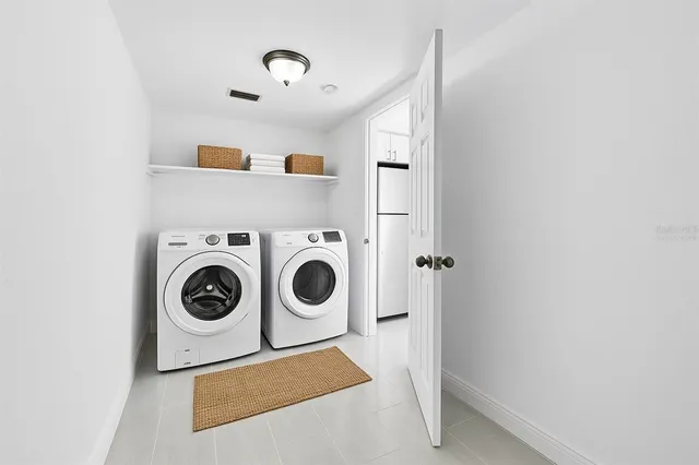 a kitchen with a refrigerator a sink and a window