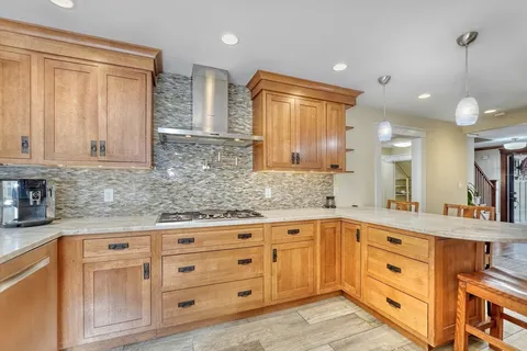 a kitchen with cabinets appliances and a counter space