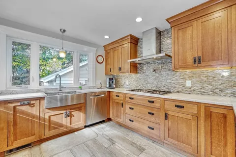 a kitchen with stainless steel appliances granite countertop a sink and cabinets