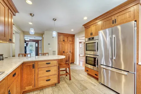 a kitchen with stainless steel appliances a refrigerator sink and microwave