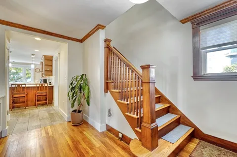 a view of entryway and hall with wooden floor