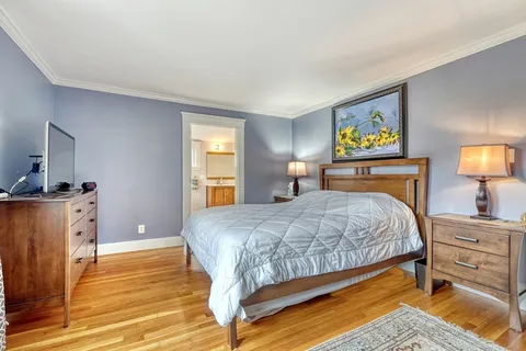 a bedroom with a bed and a dresser in it