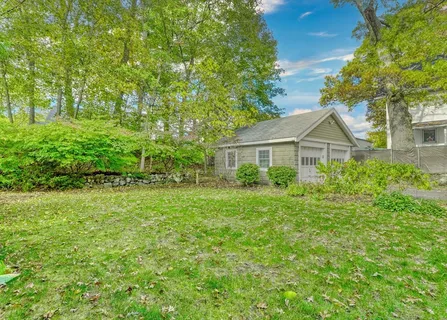 a view of backyard of house with green space