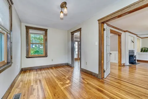 wooden floor in an empty room with a window