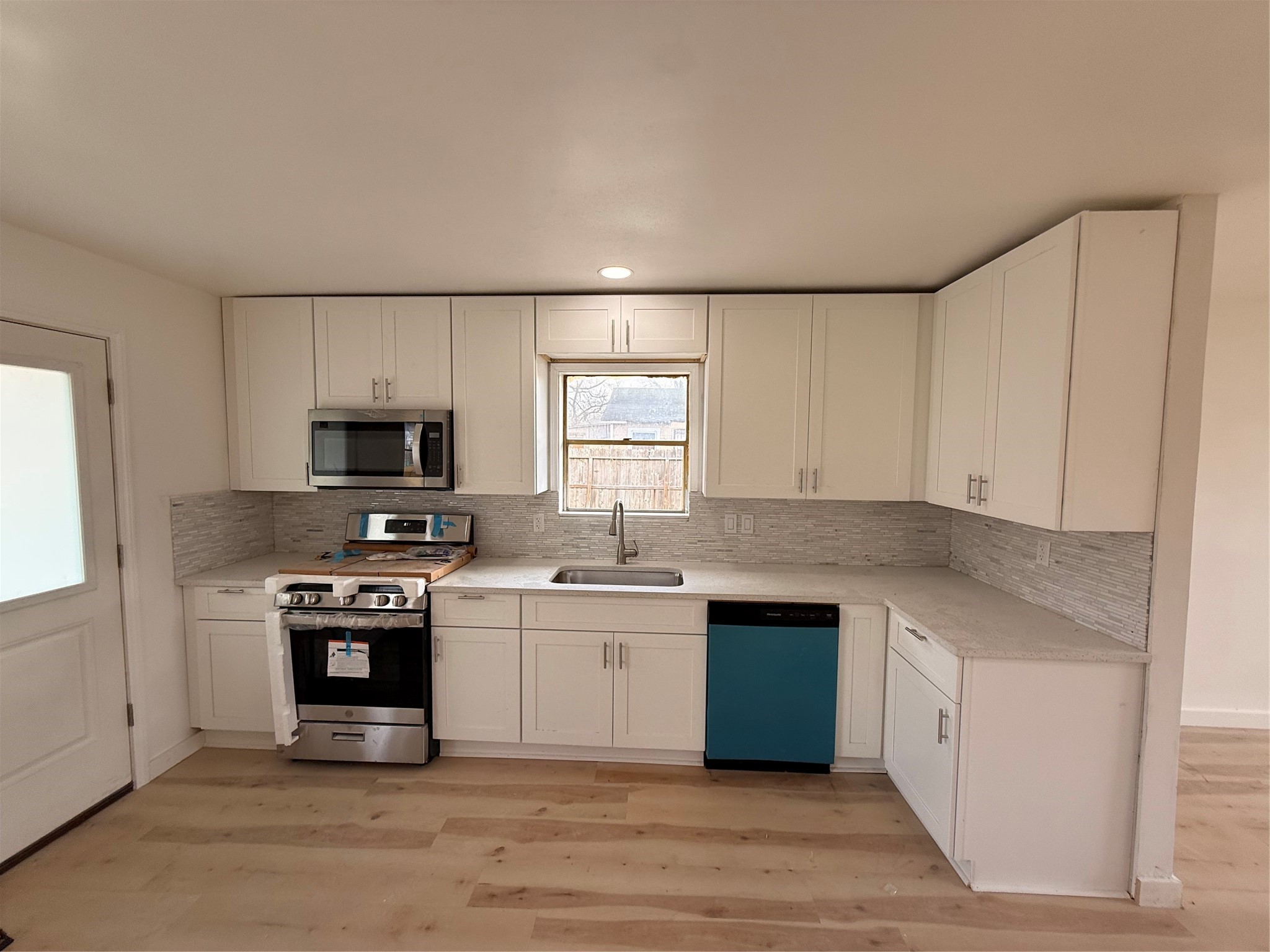 8015 Howton Street Houston, TX 77028 - Photo 8 of 11 a kitchen with stainless steel appliances granite countertop a stove a sink and a refrigerator
