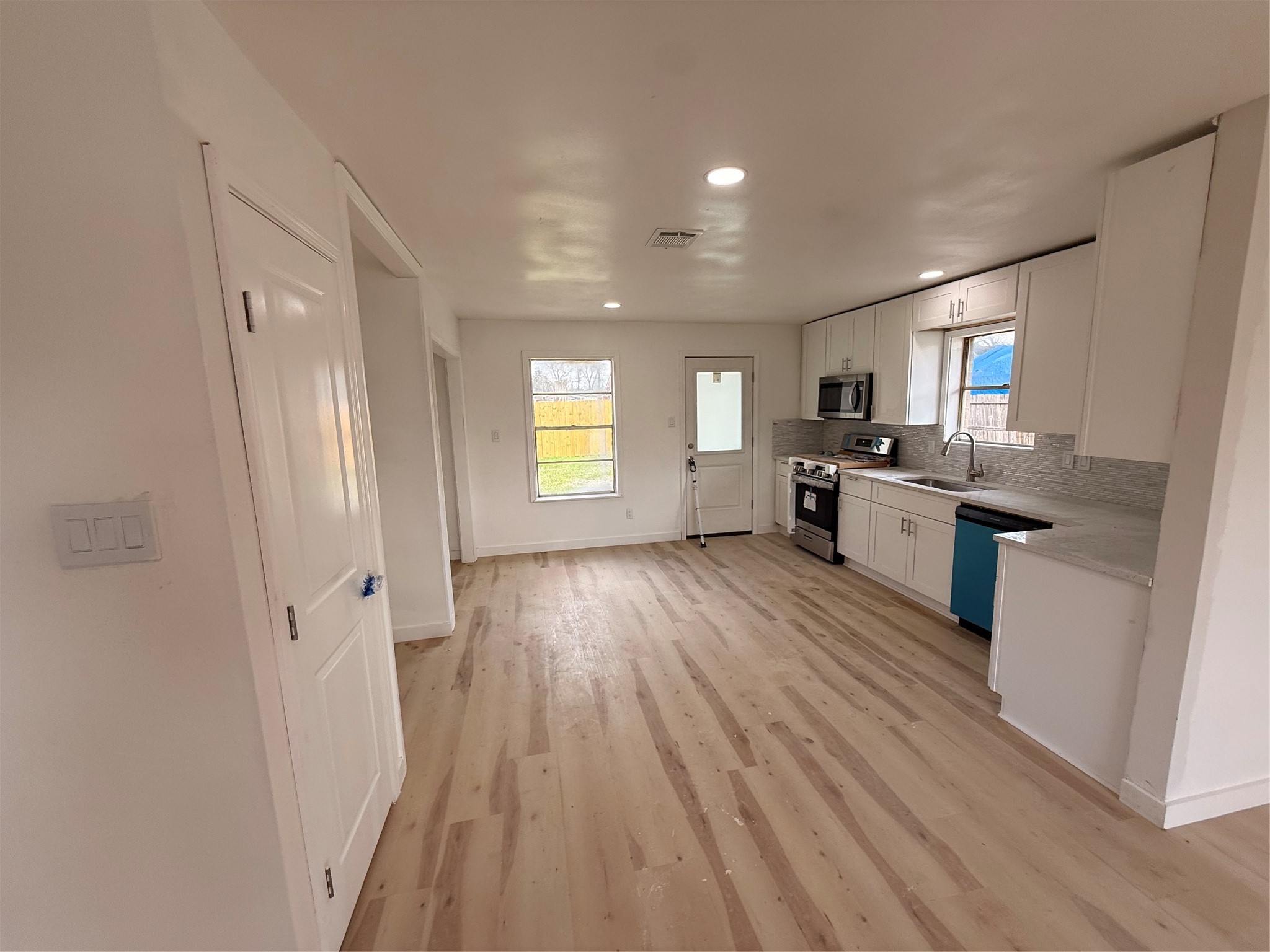 8015 Howton Street Houston, TX 77028 - Photo 9 of 11 a view of a kitchen counter space wooden floor and stainless steel appliances