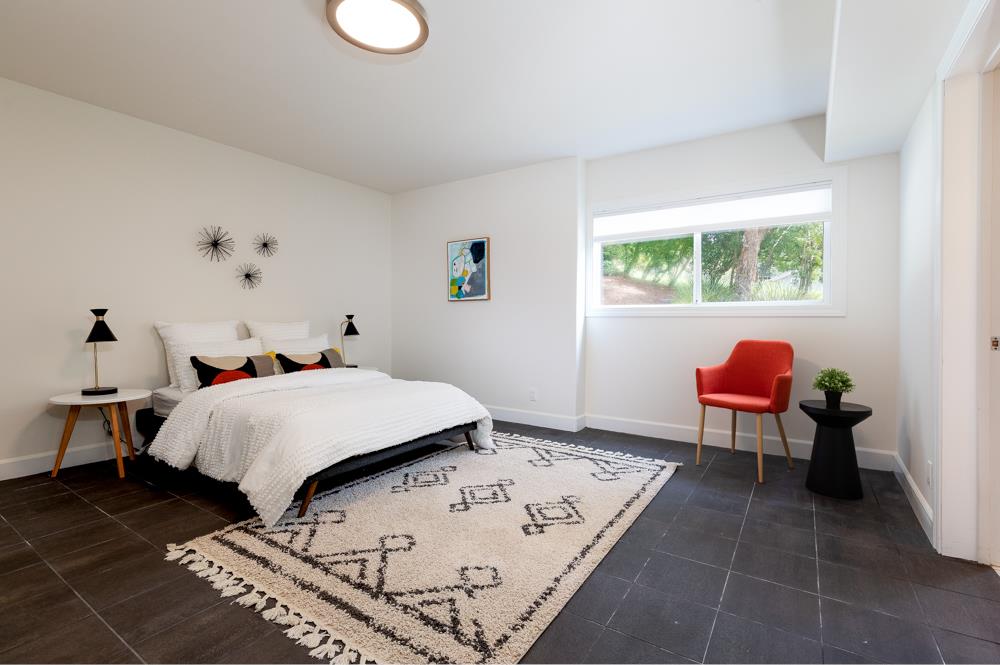 4399 Porter Gulch Road Aptos, CA 95003 - Photo 21 of 32 a bedroom with a bed and chair