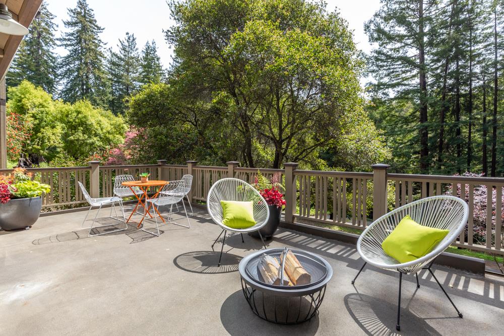 4399 Porter Gulch Road Aptos, CA 95003 - Photo 26 of 32 a backyard of a house with dining table and chairs