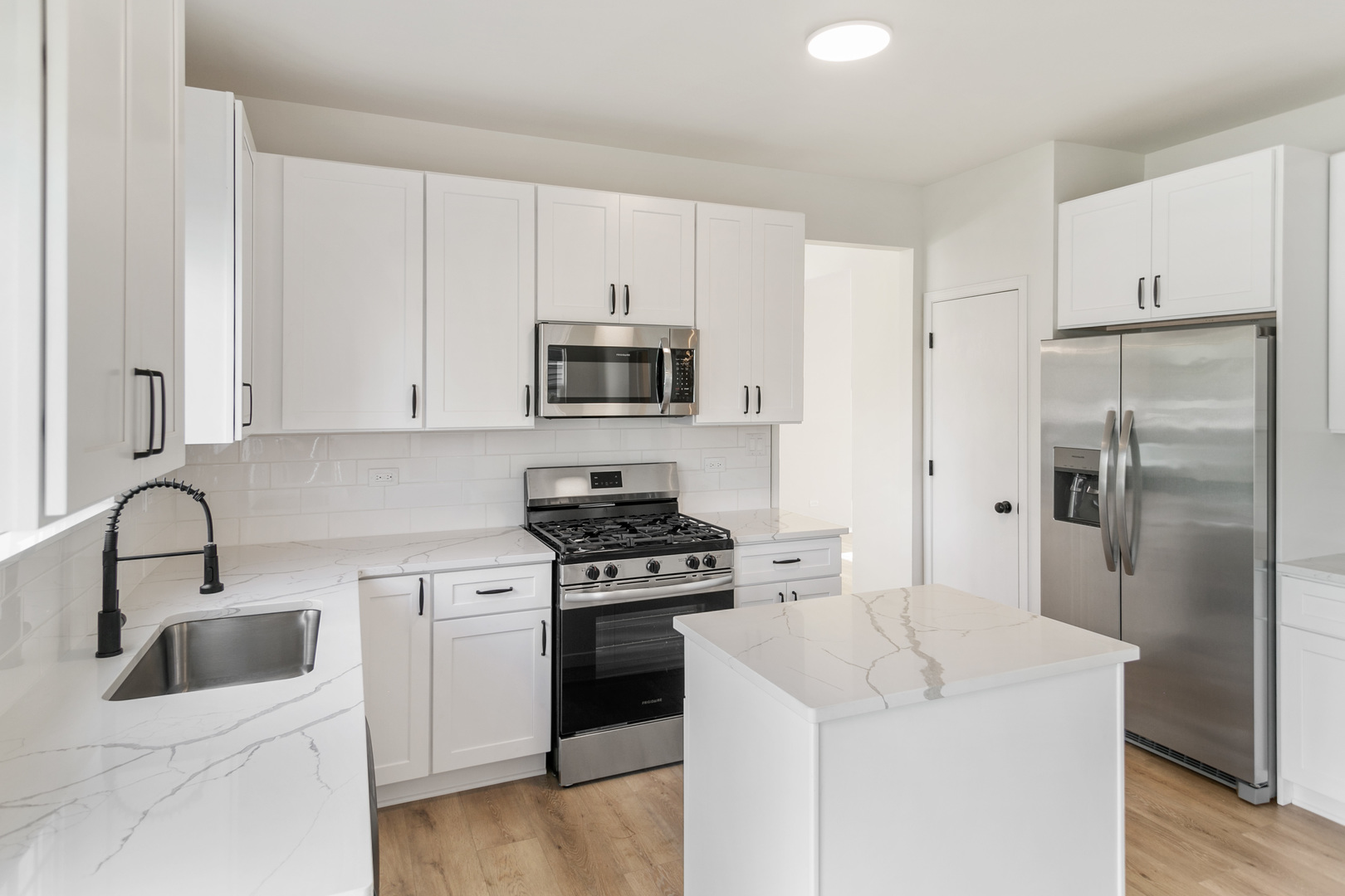 729 Wright Road University Park, IL 60484 - Photo 2 of 27 a kitchen with white cabinets and stainless steel appliances