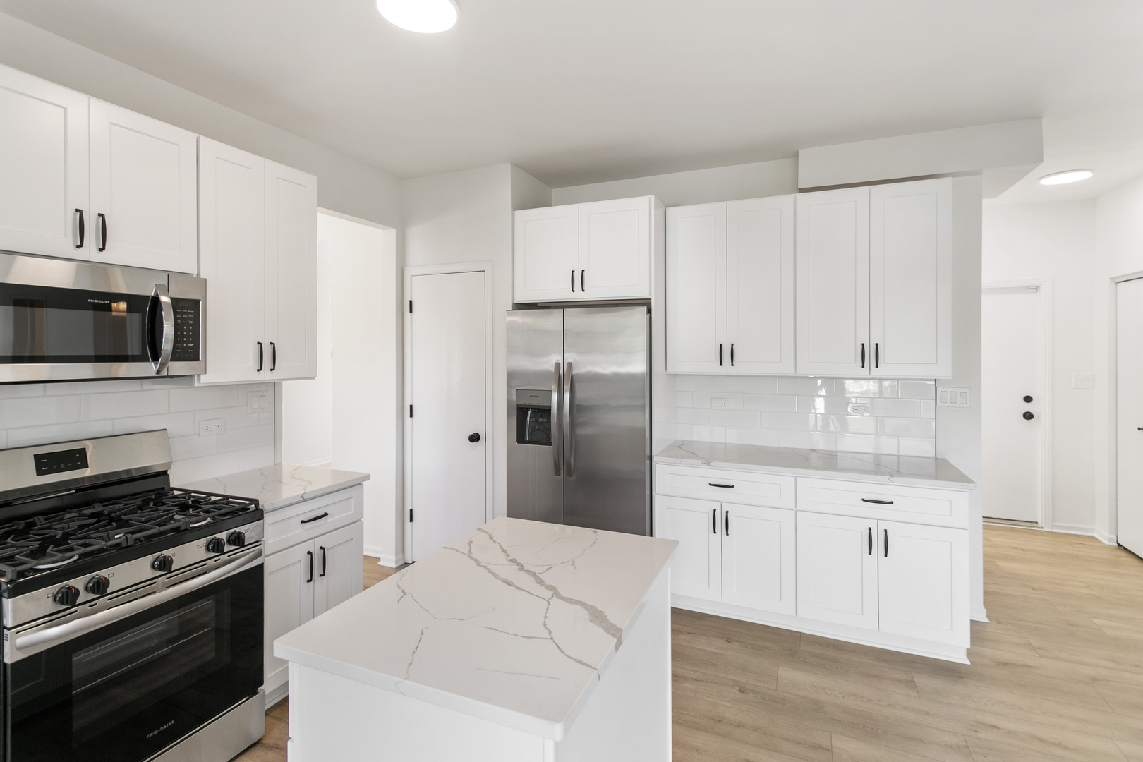 729 Wright Road University Park, IL 60484 - Photo 4 of 27 a kitchen with cabinets stainless steel appliances and wooden floor