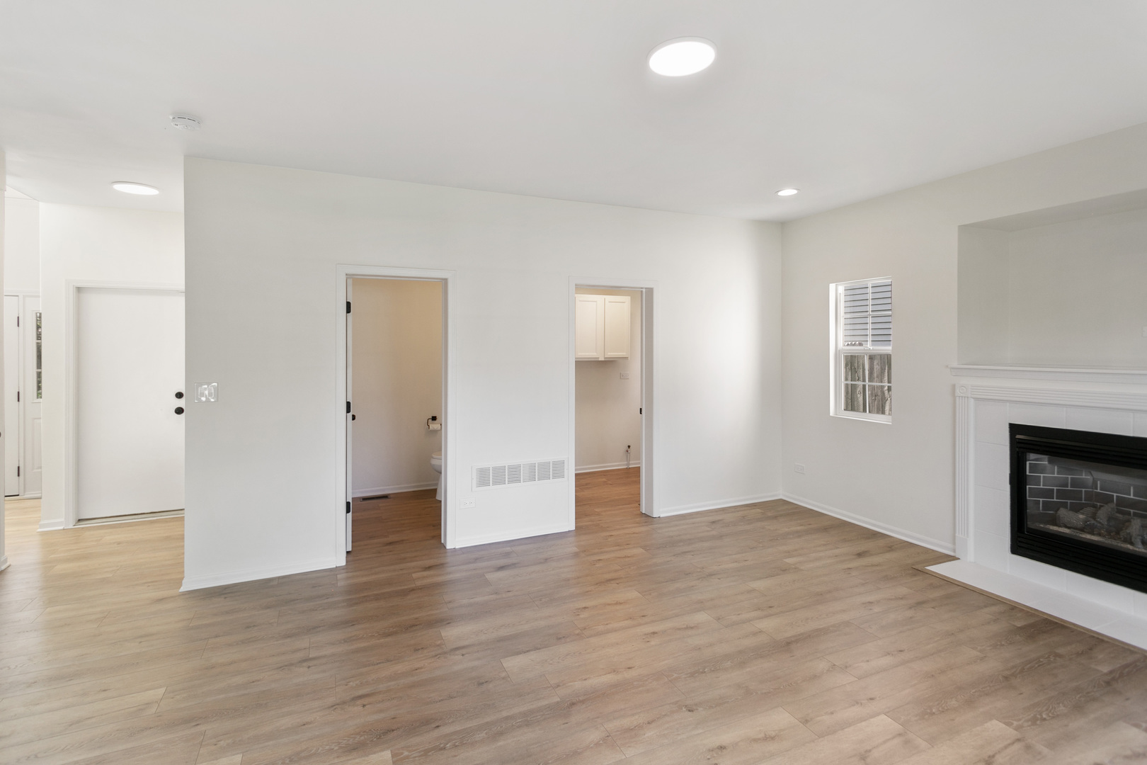 729 Wright Road University Park, IL 60484 - Photo 7 of 27 a view of an empty room with wooden floor and a fireplace