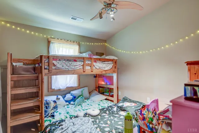 a bedroom with furniture and a flat screen tv
