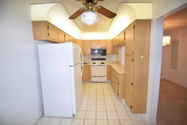a kitchen with stainless steel appliances a refrigerator and a stove