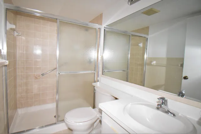a bathroom with a sink and mirror with toilet