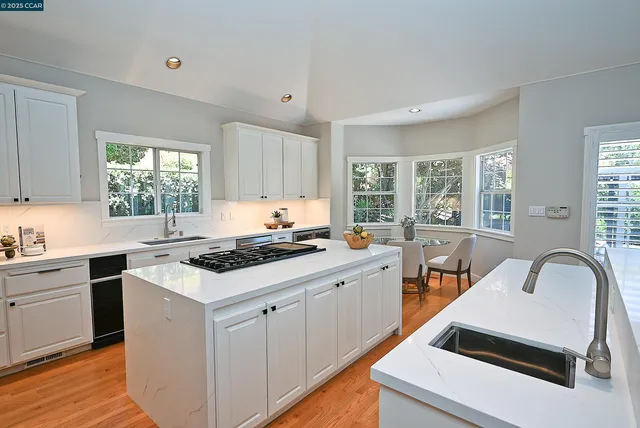 a kitchen with a stove a sink and a window