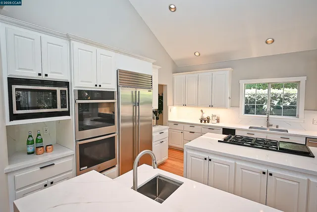 a kitchen with a refrigerator stove and sink