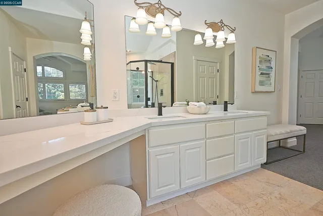 a bathroom with a sink vanity granite and a mirror