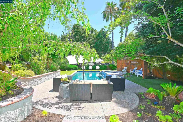 a view of a chairs and table in a backyard