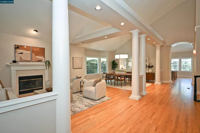 a living room with furniture wooden floor and a fireplace