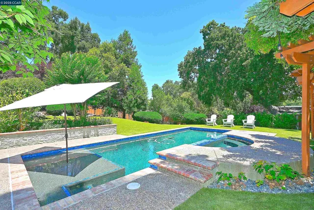 a view of a house with backyard sitting area and garden