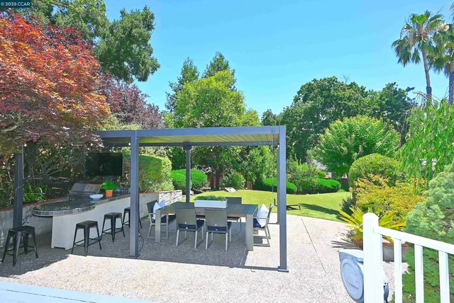 a dining room with furniture and a large window